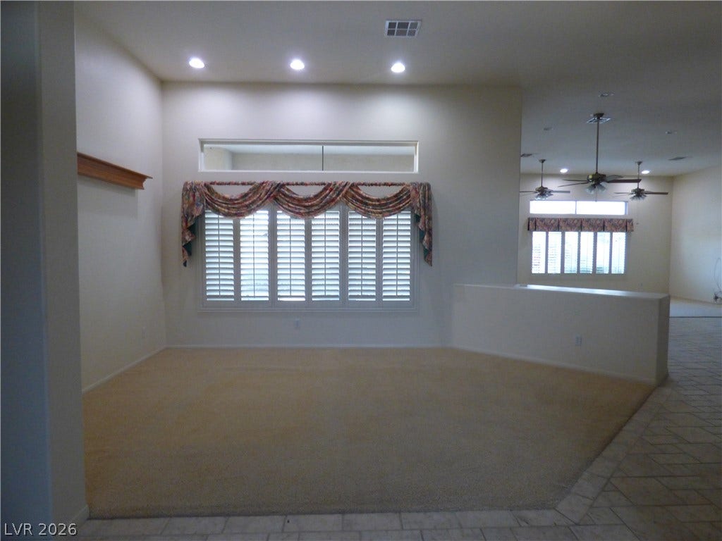 7695 Gilespie Street, Las Vegas, NV 89123 High ceilings and plantation shutters accent this open-concept main living area.