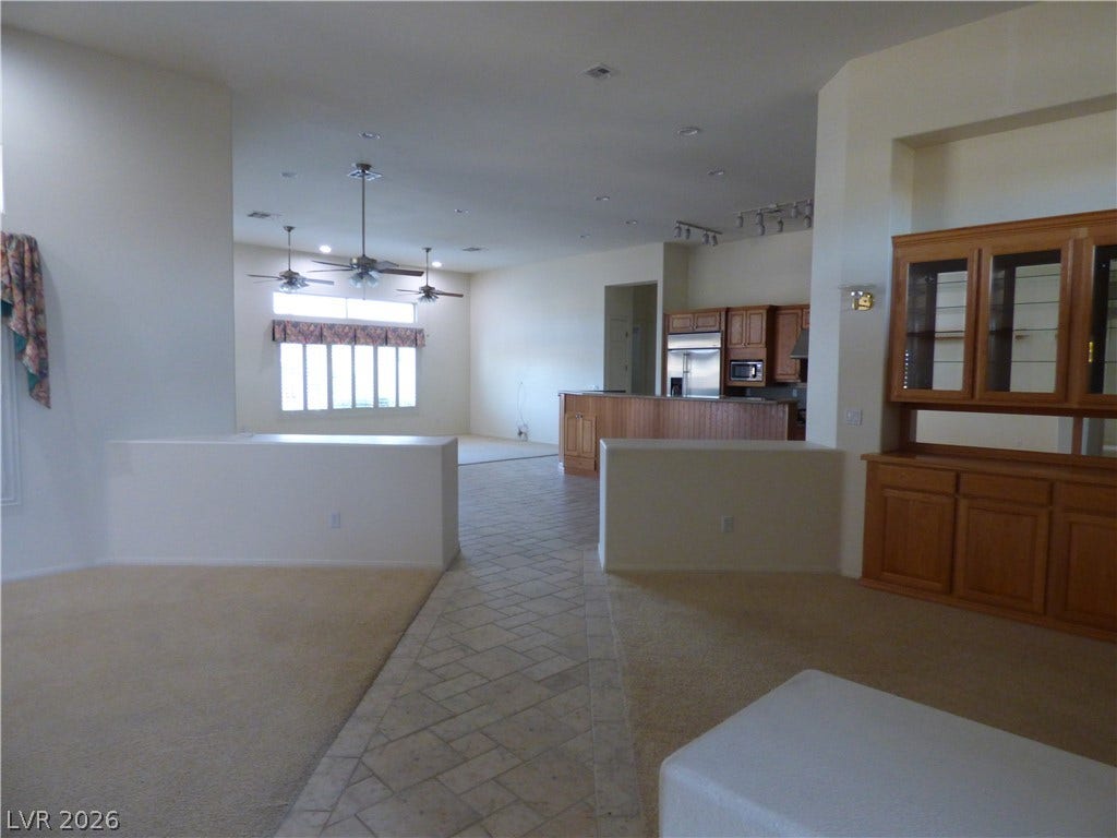7695 Gilespie Street, Las Vegas, NV 89123 An open floorplan design seamlessly connects the tiled walkway to the carpeted living areas.