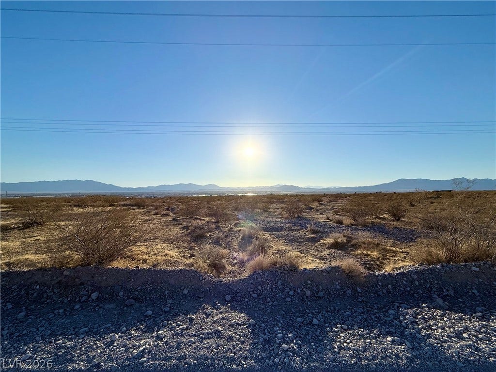 180 N Higley Road, Pahrump, NV 89060 Distant mountains frame this vast desert lot under a bright, open sky.