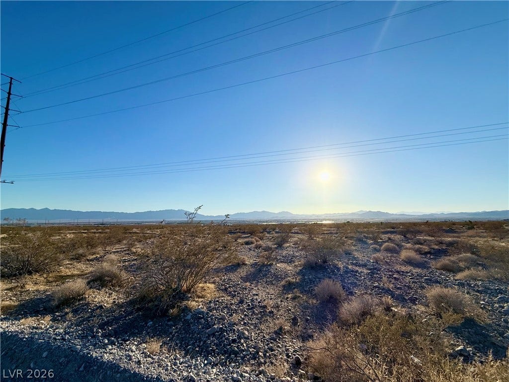 180 N Higley Road, Pahrump, NV 89060 Sunlight sweeps across vast desert terrain framed by distant mountain ranges.