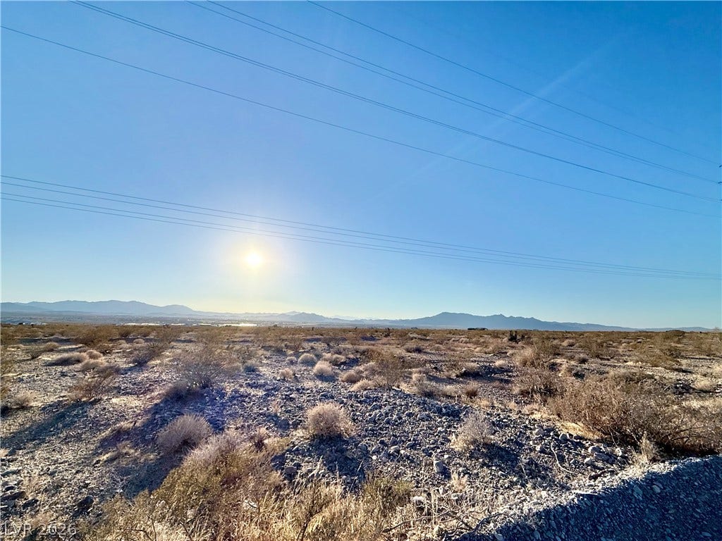 180 N Higley Road, Pahrump, NV 89060 Distant mountains frame a wide desert landscape under clear blue skies.