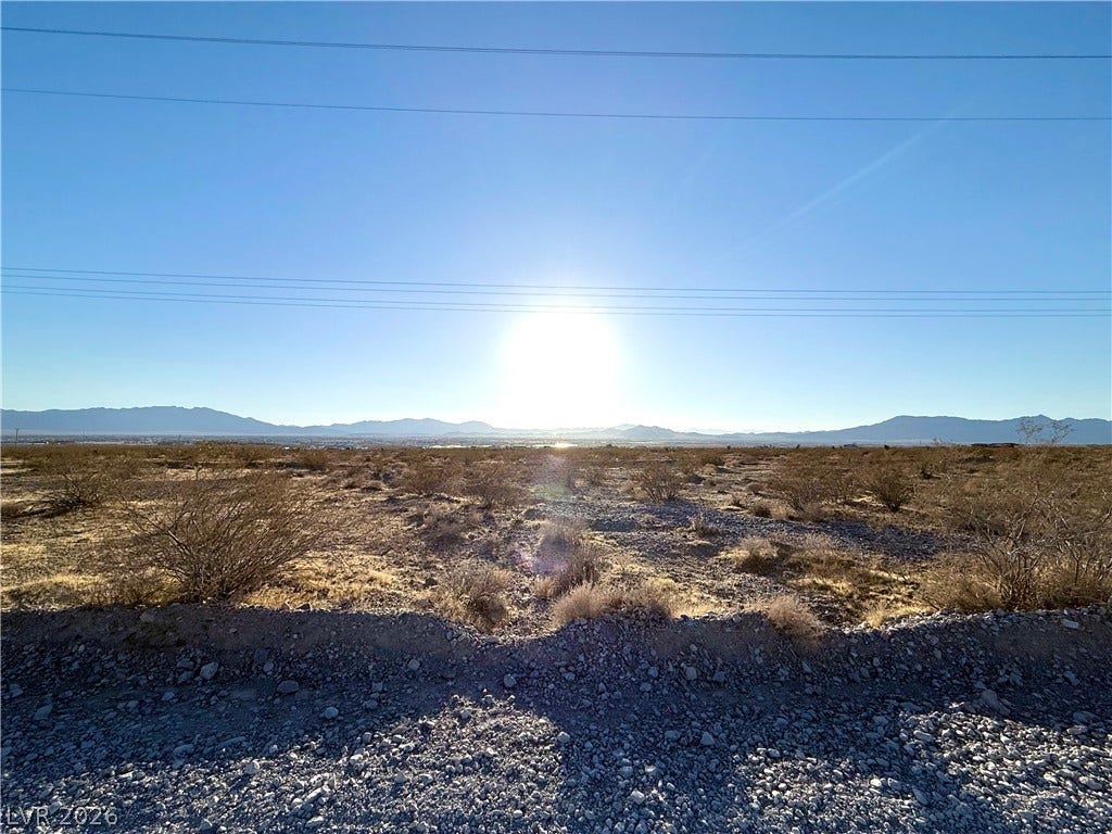 180 N Higley Road, Pahrump, NV 89060 Sweeping desert vistas and distant mountain ranges unfold under a bright, open sky.