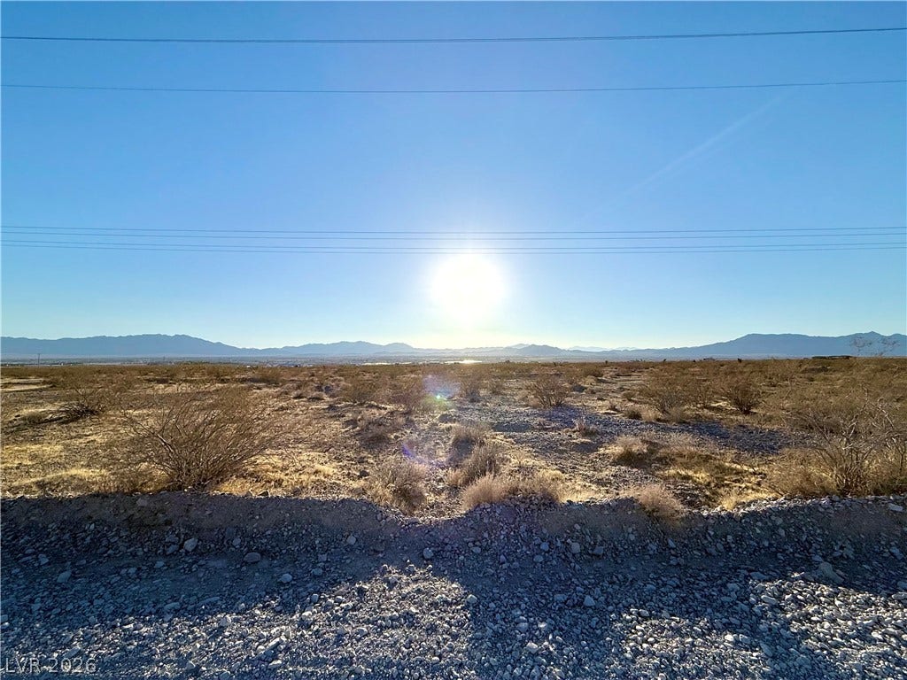 180 N Higley Road, Pahrump, NV 89060 Panoramic mountain views highlight this desert acreage under a clear sky.