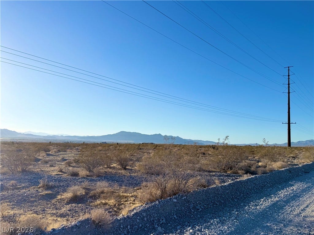 180 N Higley Road, Pahrump, NV 89060 Panoramic mountain views highlight this desert acreage bordering a quiet gravel road.