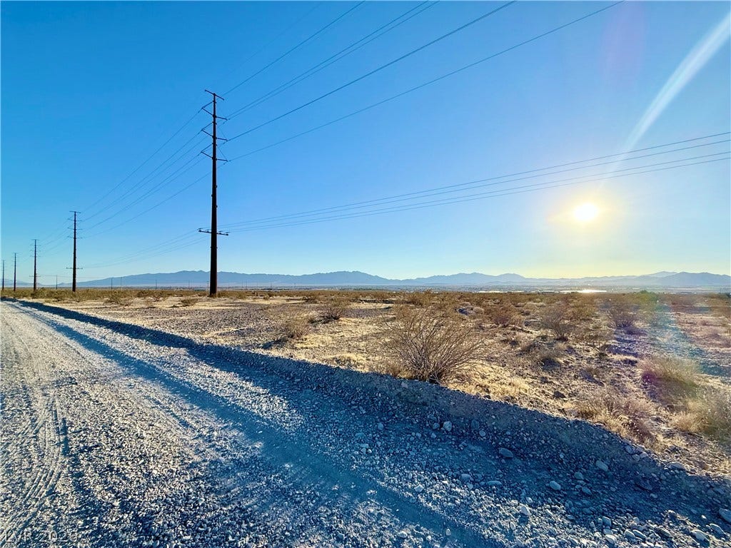 180 N Higley Road, Pahrump, NV 89060 Distant mountains frame this vast desert lot beneath clear skies and bright sunshine.
