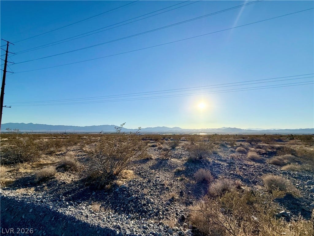 180 N Higley Road, Pahrump, NV 89060 Sunlight sweeps across the natural desert landscape toward distant mountain ranges.
