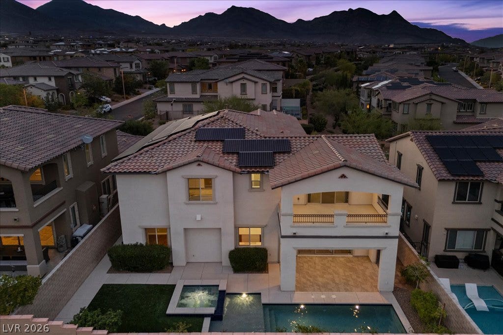 12021 Abbracci Avenue, Las Vegas, NV 89138 A private backyard oasis features a shimmering pool, spa, and a covered patio perfect for entertaining.