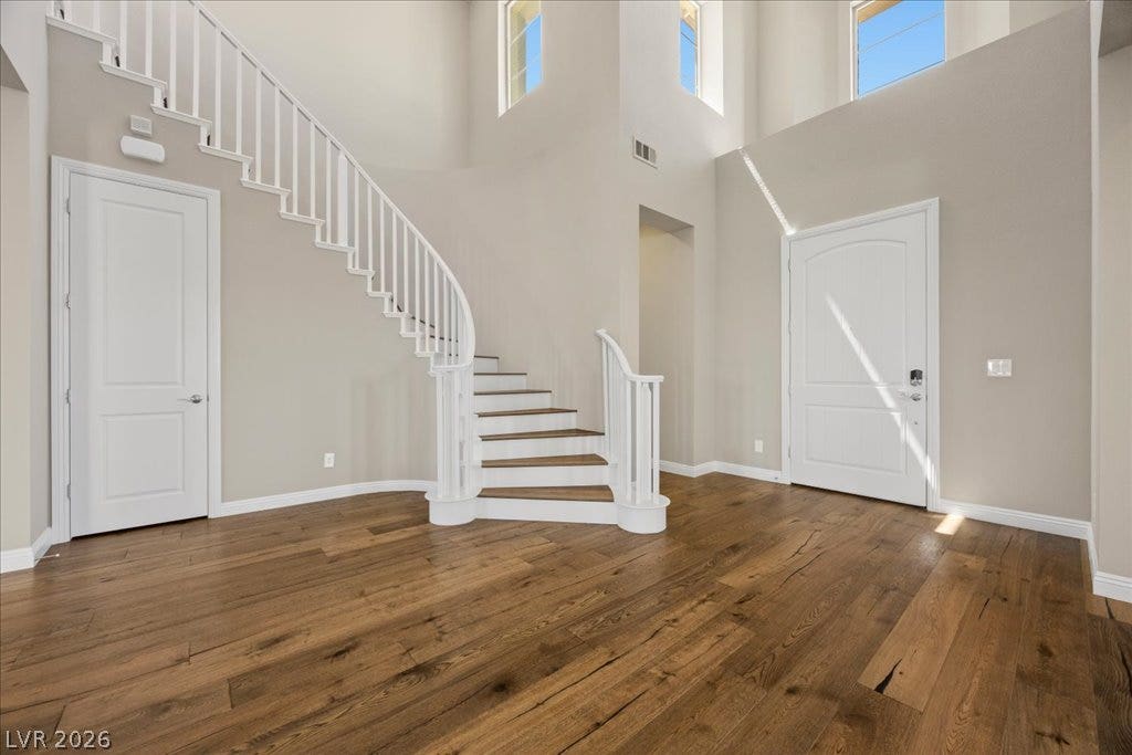 12021 Abbracci Avenue, Las Vegas, NV 89138 A grand entrance with a graceful curved staircase and sun-filled high ceilings welcomes all guests.