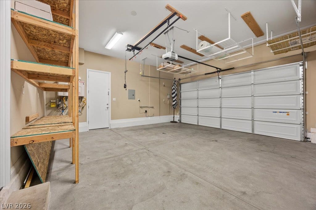 12021 Abbracci Avenue, Las Vegas, NV 89138 Secure garage with ample overhead storage, workbench, and convenient side door access.