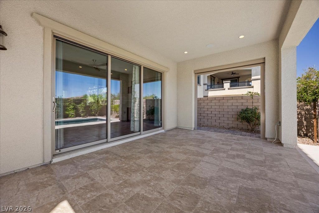 12021 Abbracci Avenue, Las Vegas, NV 89138 A spacious covered patio invites outdoor enjoyment, overlooking a refreshing pool.