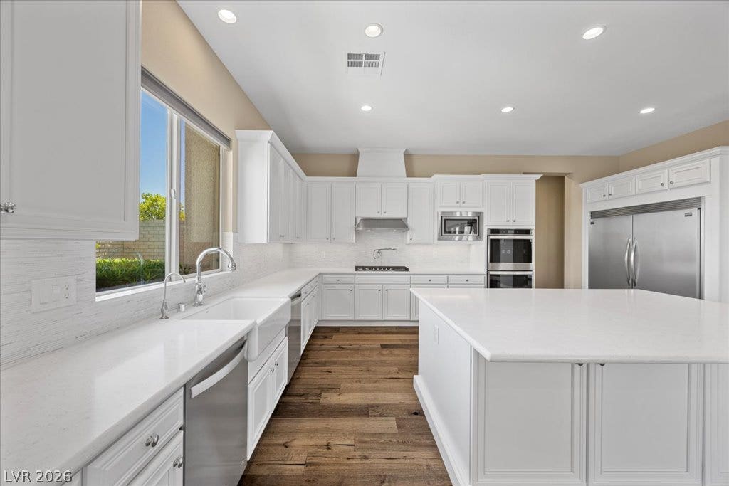 12021 Abbracci Avenue, Las Vegas, NV 89138 A well-lit kitchen featuring stainless steel appliances and a spacious center island for culinary creations.