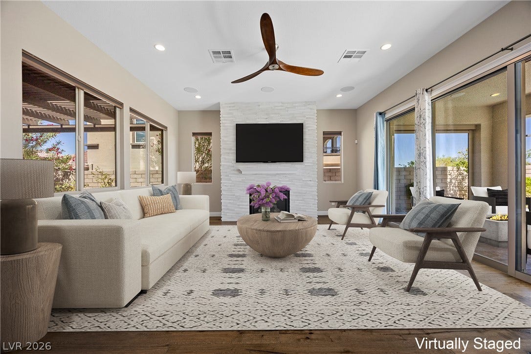 12021 Abbracci Avenue, Las Vegas, NV 89138 Virtually Staged A refined living area boasts a sleek fireplace, wood flooring, and an elegant ceiling fan.