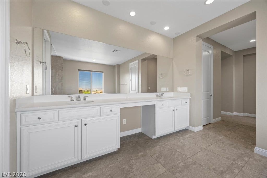 12021 Abbracci Avenue, Las Vegas, NV 89138 Bright, spacious bathroom with ample counter space and dual vanities perfect for daily routines.