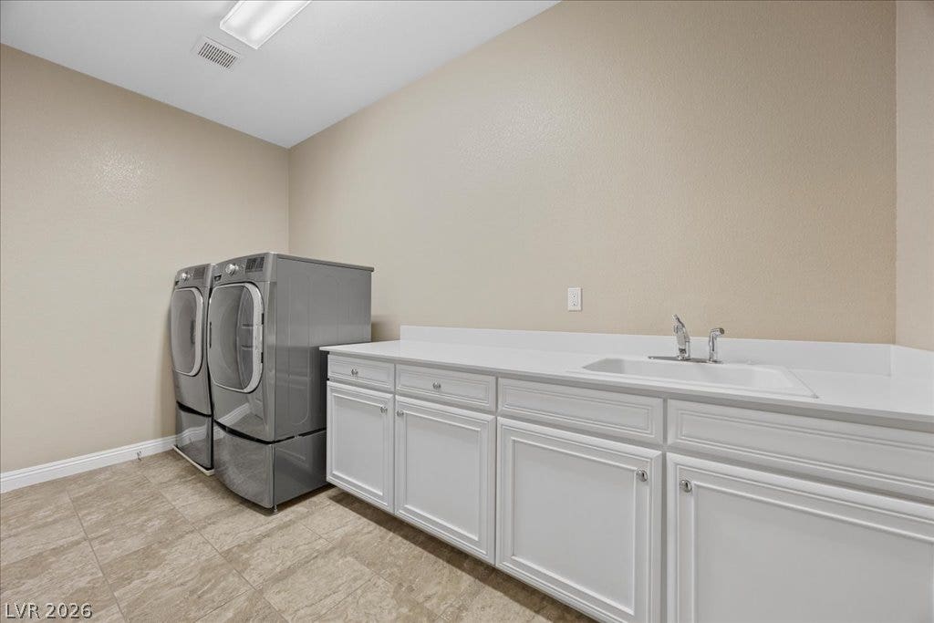 12021 Abbracci Avenue, Las Vegas, NV 89138 A dedicated laundry room with functional cabinetry and a convenient utility sink.