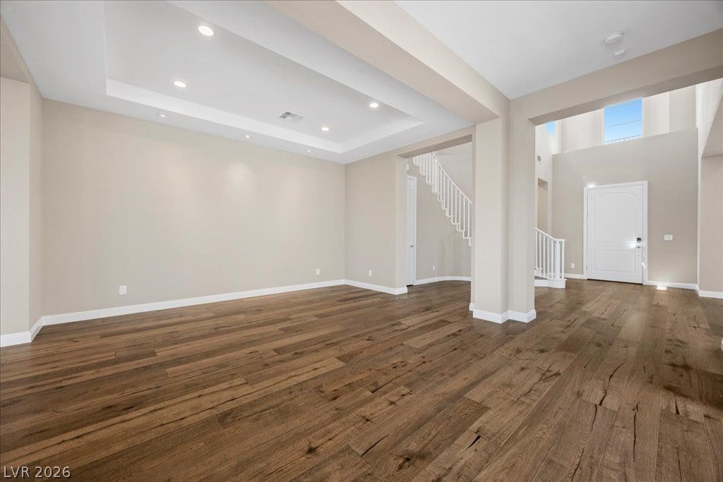 12021 Abbracci Avenue, Las Vegas, NV 89138 Rich hardwood floors flow through this luminous open-concept living space with a grand entryway and architectural ceilings.