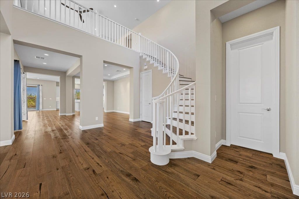 12021 Abbracci Avenue, Las Vegas, NV 89138 Elegant hardwood flooring flows throughout this open-concept interior, leading to a grand curved staircase.