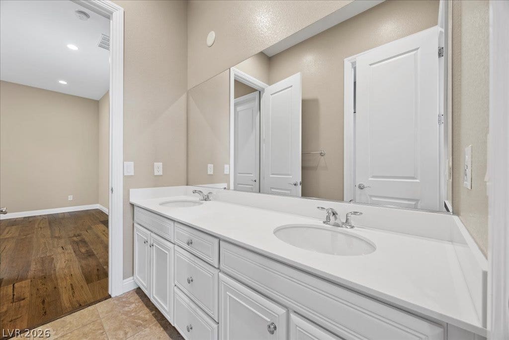 12021 Abbracci Avenue, Las Vegas, NV 89138 Double vanity with pristine countertops and integrated sinks in a well-appointed bathroom.