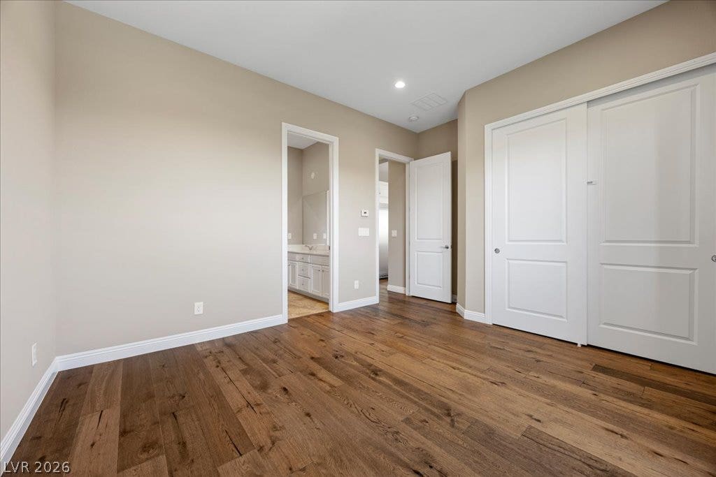 12021 Abbracci Avenue, Las Vegas, NV 89138 Rich hardwood flooring extends throughout this well-appointed bedroom, offering both durability and timeless appeal.