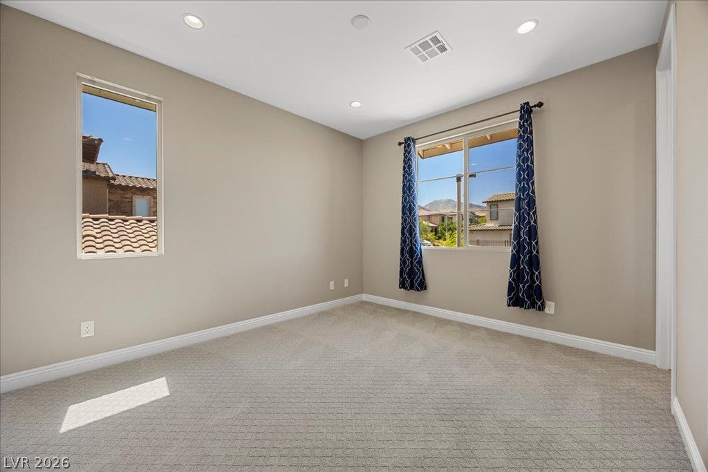 12021 Abbracci Avenue, Las Vegas, NV 89138 Well-lit room with ample space, perfect for quiet reflection or productive pursuits.