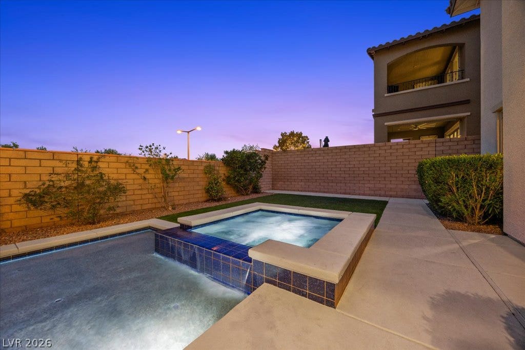 12021 Abbracci Avenue, Las Vegas, NV 89138 Relax in the private spa and pool under the twilight sky.