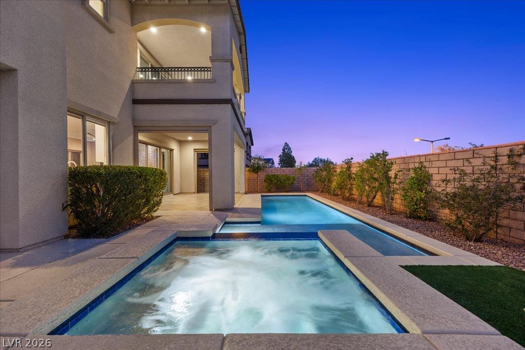 12021 Abbracci Avenue, Las Vegas, NV 89138 An inviting backyard oasis offers a sparkling pool and spa with lush landscaping.