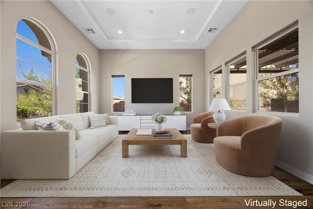12021 Abbracci Avenue, Las Vegas, NV 89138 Virtually Staged Natural light floods this living space, highlighting its vaulted ceilings and rich wood flooring.