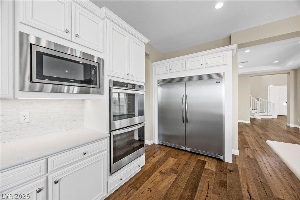 12021 Abbracci Avenue, Las Vegas, NV 89138 Culinary delights await in this modern kitchen with premium stainless steel appliances and rich hardwood flooring.