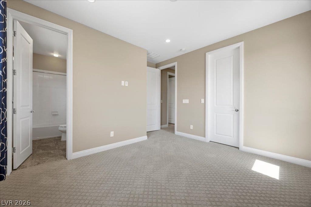 12021 Abbracci Avenue, Las Vegas, NV 89138 A quiet bedroom with light carpet offers a tranquil retreat.