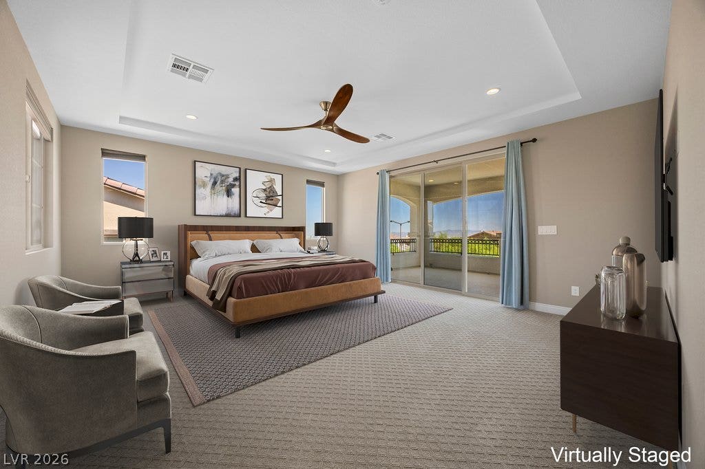 12021 Abbracci Avenue, Las Vegas, NV 89138 Virtually Staged Natural light floods this spacious primary bedroom, featuring a tray ceiling and direct access to a private balcony.