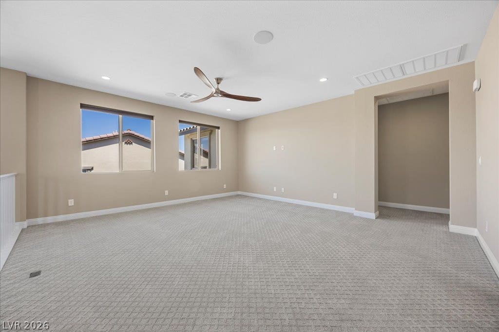 12021 Abbracci Avenue, Las Vegas, NV 89138 A versatile open-concept living area with ample natural light, ideal for various configurations.