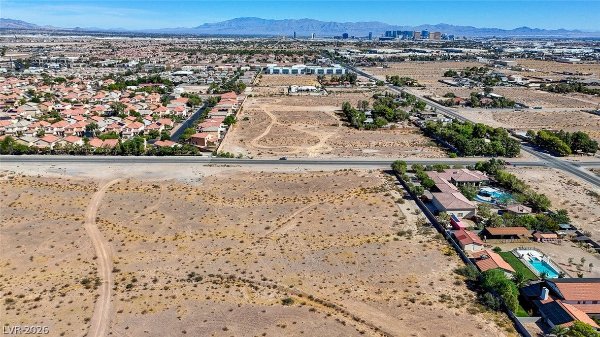 Pebble Road, Las Vegas, NV 89124 Distant mountains and a sparkling city skyline frame this expansive desert parcel.