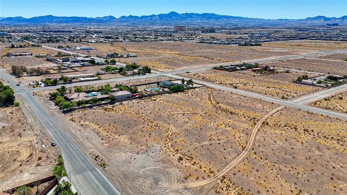 Pebble Road, Las Vegas, NV 89124 Distant mountain ranges border the vast desert landscape under clear blue skies.