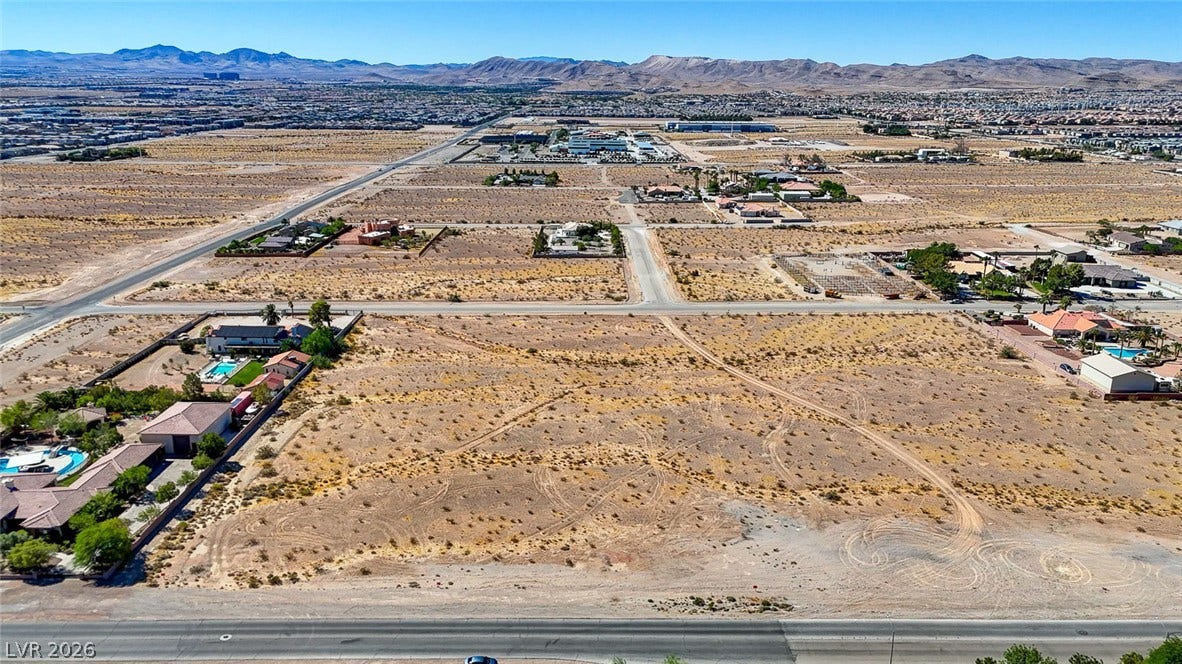 Pebble Road, Las Vegas, NV 89124 An expansive desert lot presents a prime opportunity for development against a mountain backdrop.