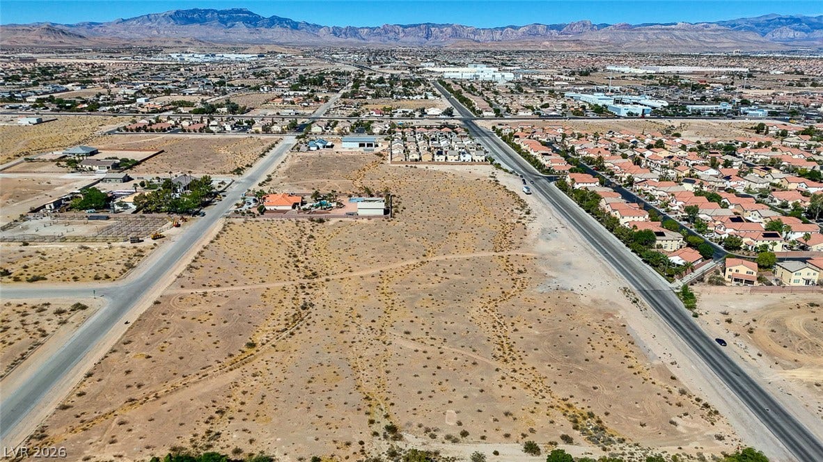 Pebble Road, Las Vegas, NV 89124 Expansive desert acreage borders paved roads with majestic mountain ranges lining the distant horizon.