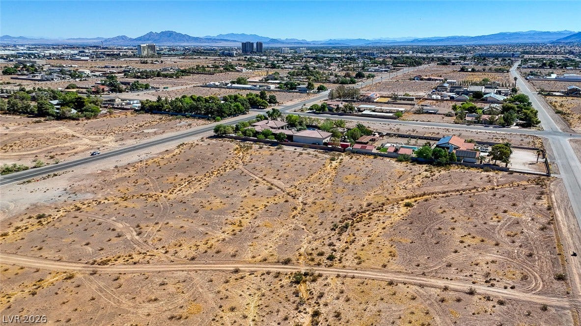 Pebble Road, Las Vegas, NV 89124 Distant mountains frame this vast desert lot with paved road access.