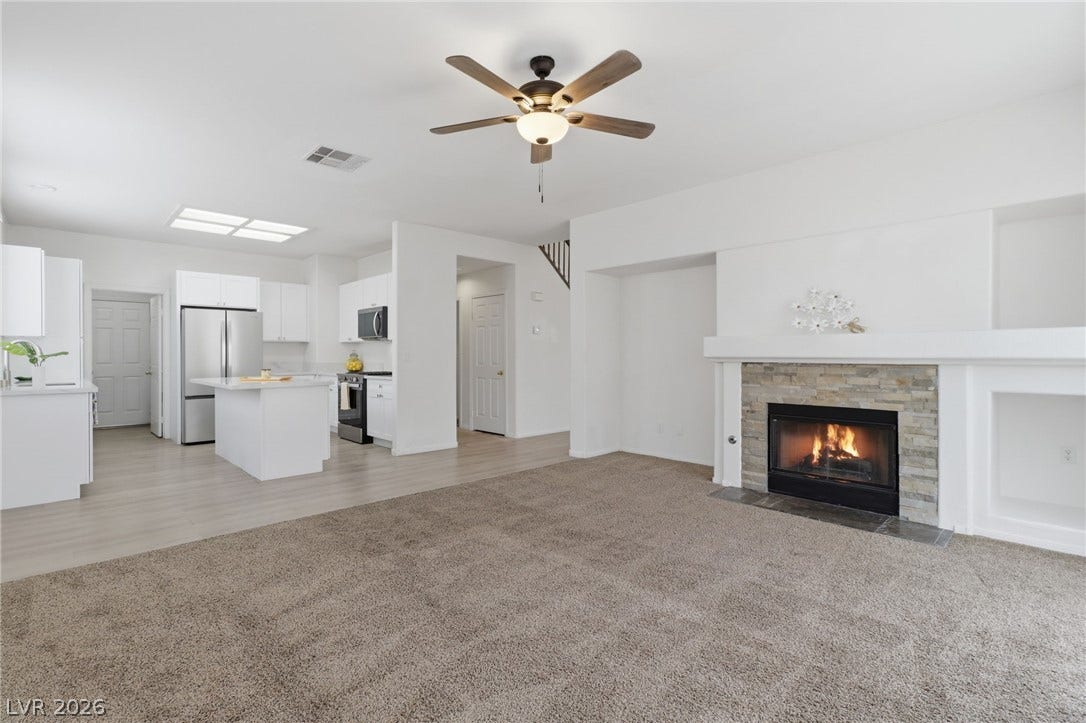 1891 Eagle Flight Lane, Henderson, NV 89012 An open floorplan seamlessly connects the cozy fireplace hearth to the adjacent kitchen space.