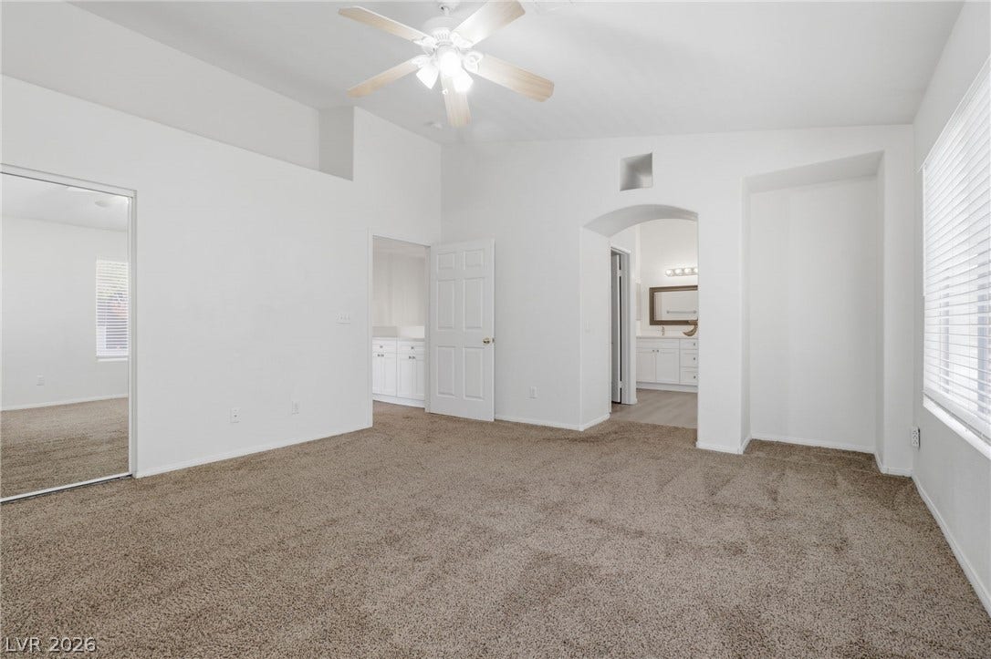 1891 Eagle Flight Lane, Henderson, NV 89012 High vaulted ceilings and soft carpet define this comfortable primary bedroom suite.