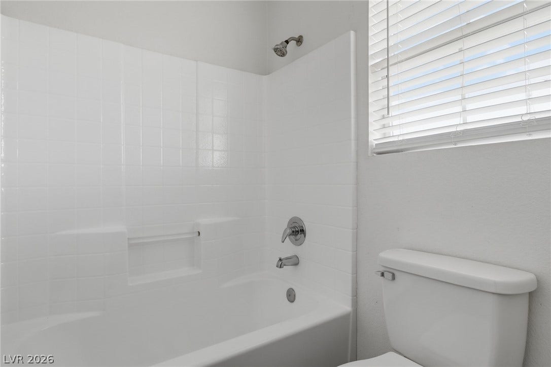 1891 Eagle Flight Lane, Henderson, NV 89012 Clean lines and classic tiling define this well-lit bathroom space.