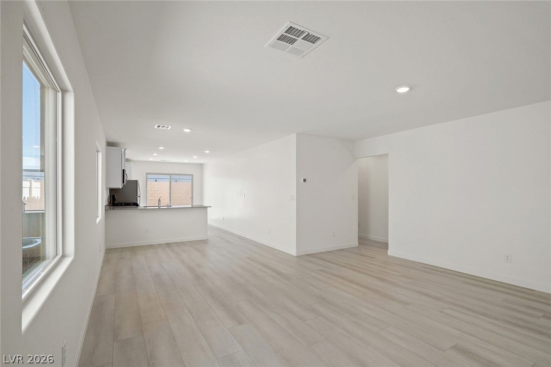 6760 Violet Cascade Avenue, Las Vegas, NV 89156 Clean lines and light wood flooring define this open-concept main living area.