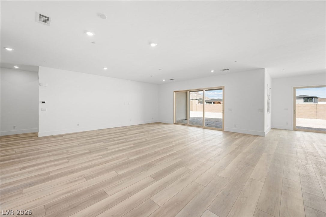 12428 Breezy Bluff Avenue, Las Vegas, NV 89138 Laminated floors and recessed lighting enhance this expansive interior with sliding glass doors.