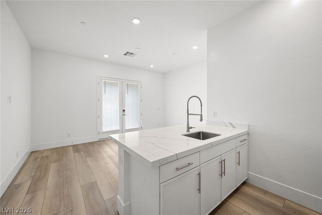 12428 Breezy Bluff Avenue, Las Vegas, NV 89138 An open floorplan connects the modern wet bar area with the light-filled living space.