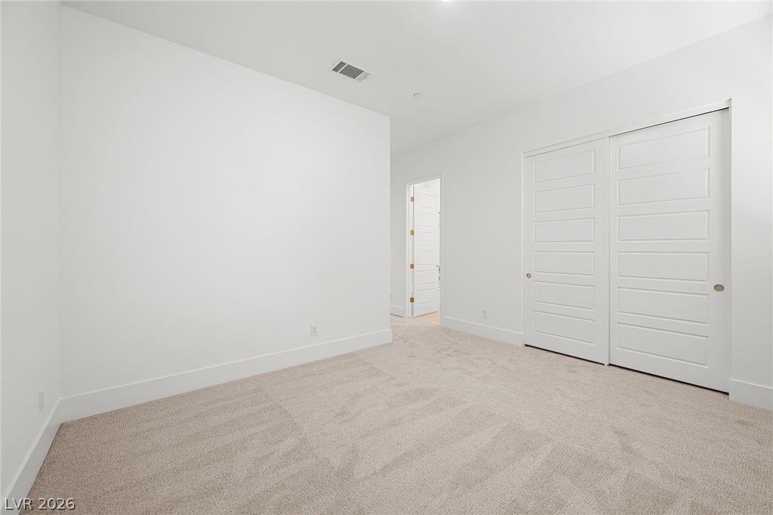 12428 Breezy Bluff Avenue, Las Vegas, NV 89138 Plush carpeting and clean lines define this versatile bedroom space featuring sliding closet doors.