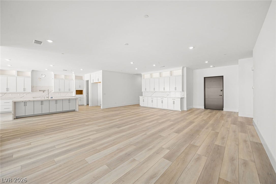 12428 Breezy Bluff Avenue, Las Vegas, NV 89138 Gleaming wood floors anchor a wide-open floor plan with clean lines and custom cabinetry.