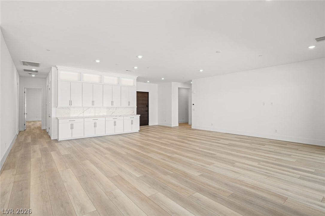 12428 Breezy Bluff Avenue, Las Vegas, NV 89138 Plank flooring and extensive built-in cabinetry define this versatile open living space.