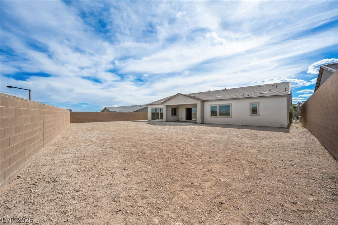 12428 Breezy Bluff Avenue, Las Vegas, NV 89138 An enclosed backyard features a concrete patio and a block wall perimeter.