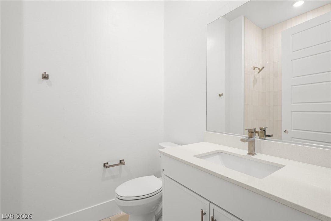 12428 Breezy Bluff Avenue, Las Vegas, NV 89138 Clean lines and a stone counter highlight this minimalist powder room.