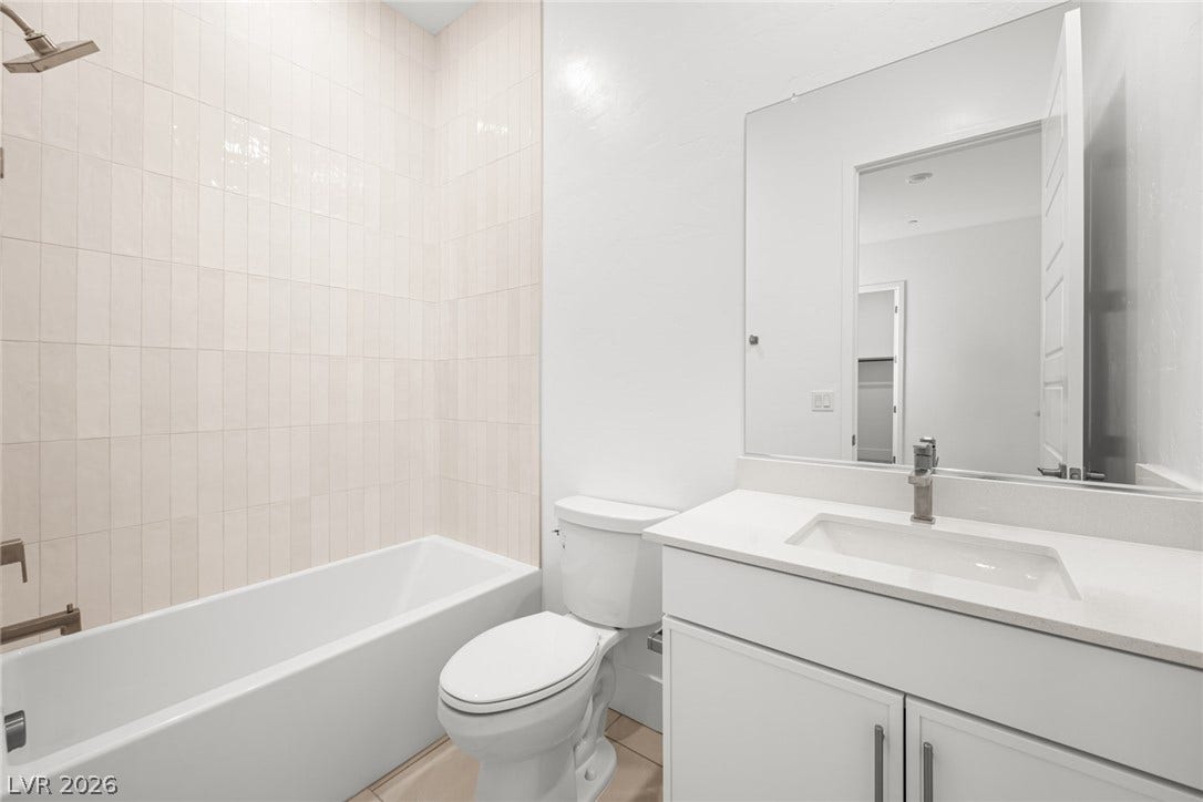 12428 Breezy Bluff Avenue, Las Vegas, NV 89138 Clean lines and a tiled tub surround define this pristine secondary bath.