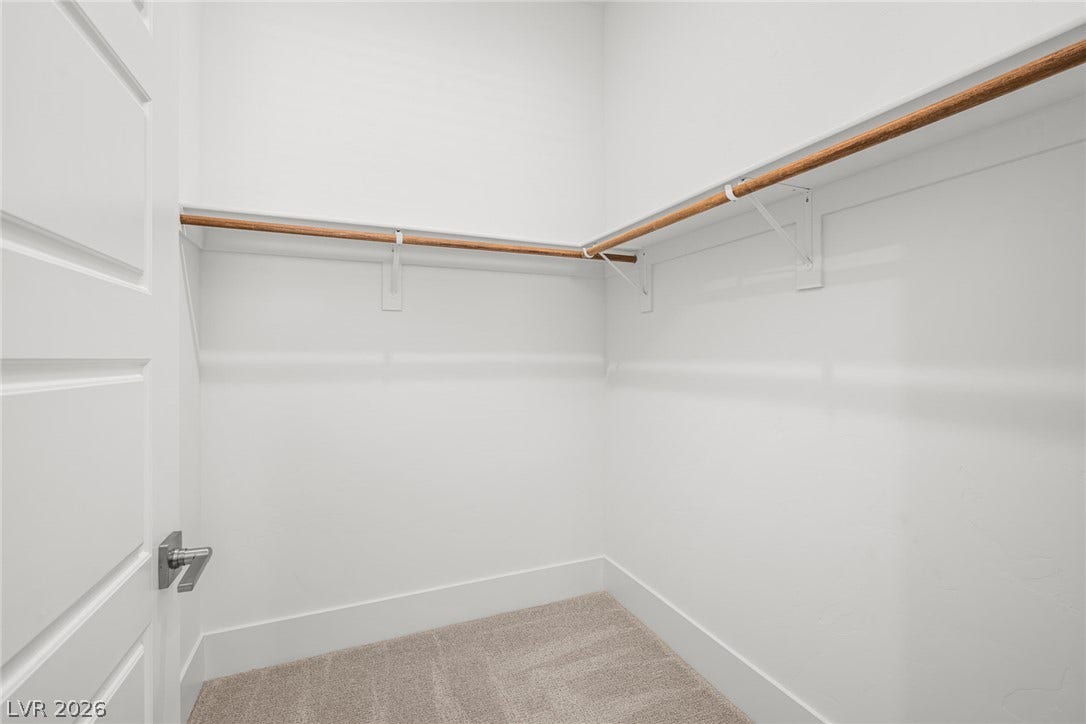 12428 Breezy Bluff Avenue, Las Vegas, NV 89138 Ample closet space features built-in shelving, wooden hanging rods, and soft carpeting throughout.