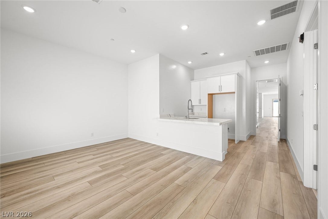 12428 Breezy Bluff Avenue, Las Vegas, NV 89138 Smooth wood-look flooring and recessed lighting define this versatile open-concept living and kitchen space.