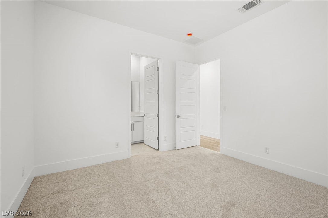 12428 Breezy Bluff Avenue, Las Vegas, NV 89138 Soft carpeting underfoot complements the clean architectural lines of this quiet secondary bedroom.